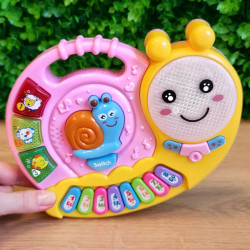 Muzikālas klavieres gliemezis rozā